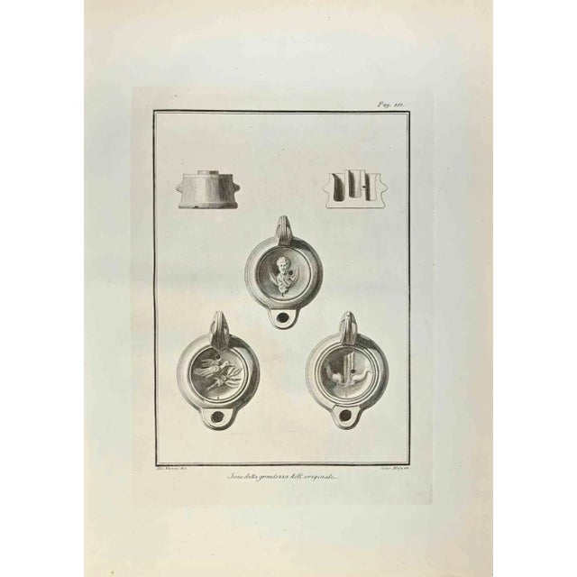 Oil Lamp with Bird and Caesar Bust from "Antiquities of Herculaneum" is an etching on paper realized by Giuseppe Aloja in...
