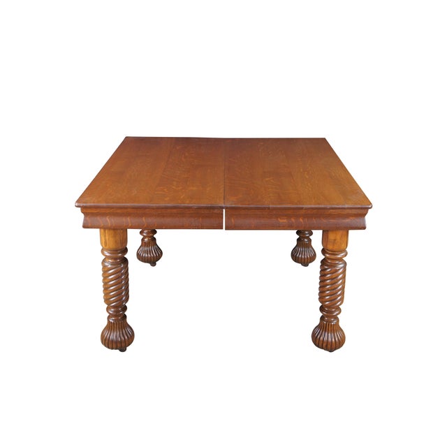 An exceptional, turn-of-the-century American extension dining table crafted from solid, premium quarter-sawn oak (commonly...