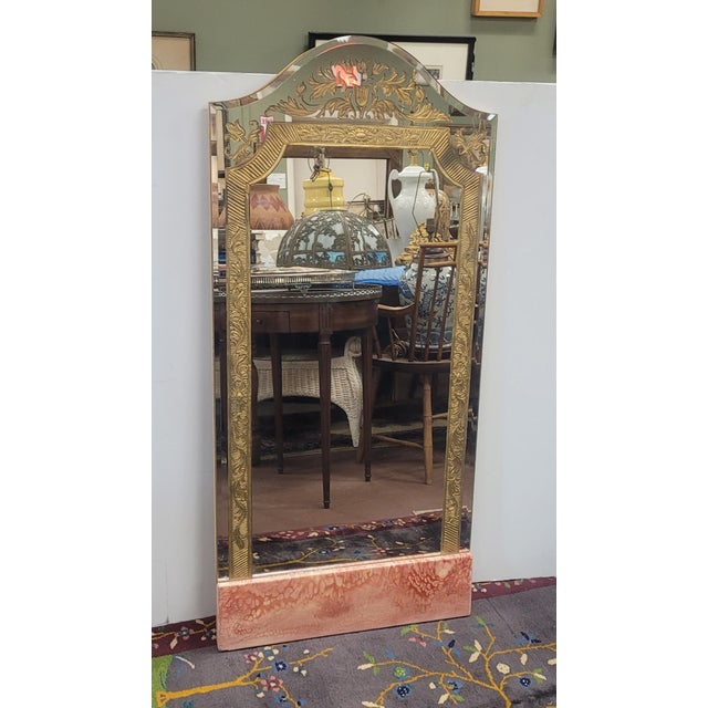 Very fine and unusual art deco wall mirror. Features beveled arched mirror glass with underneath foil design the bottom...