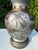 Vintage sculptural table lamp featuring raised animal relief decoration and a warm bronze-tone finish. The vessel-form...