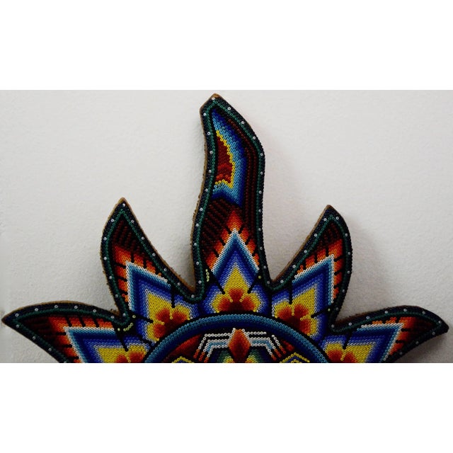 This is a very intricate hand beaded Mexican Huichol sun wall decor. This unique piece is comprised of vibrant glass beads...