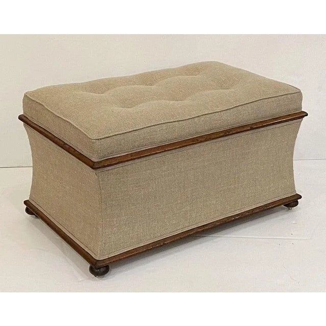 A handsome, comfortable English rectangular upholstered trunk or pouffe ottoman, featuring an upholstered seat with...