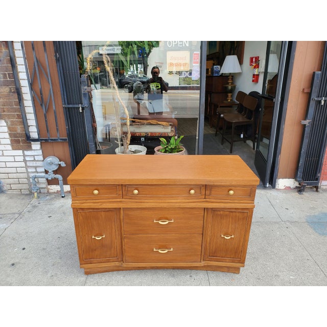Vintage early 50s mid-century style oak sideboard or credenza. The piece has five drawers, that are made out of oak and...