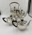 A Classic Adams design hot water urn with a coffee pot and 2 tea pots, England circa 1910. Marked EPNS. A gadrooned with...