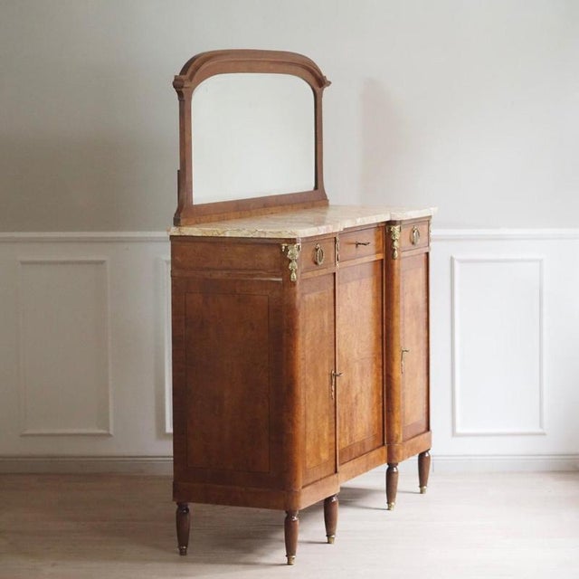 Elegant french mirrored chest of drawers with marble and large mirror surface, circa 1890. The original cream-colored...