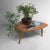 Vintage wooden coffee table, probably originating from Belgium. The table features an organically shaped top with soft,...