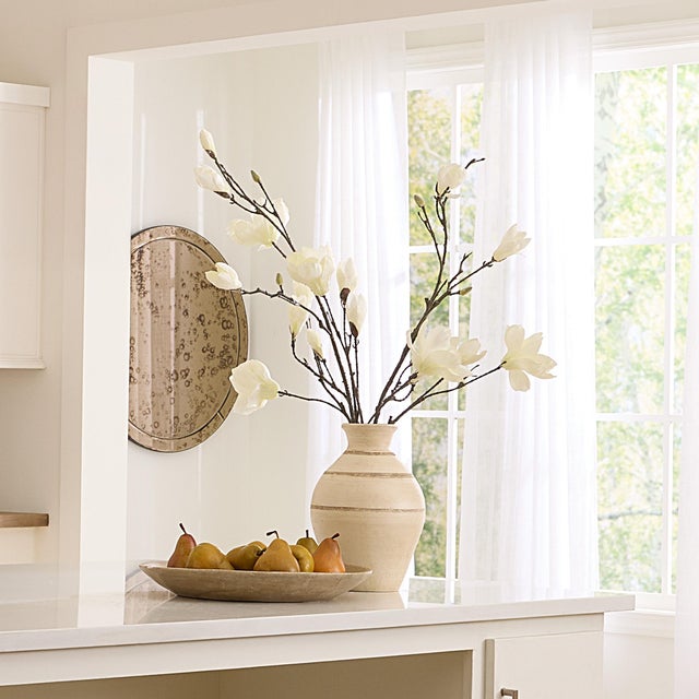 Each handcrafted ceramic vase is a study in simplicity and grace. With its finely etched texture and gently luminous...