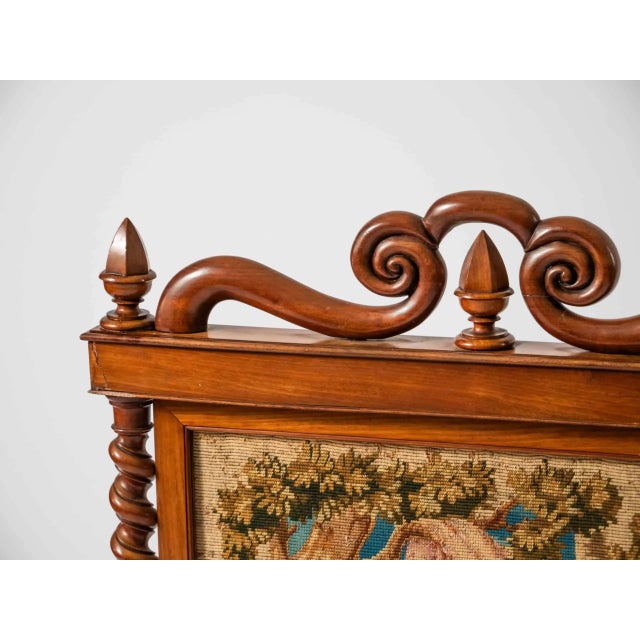 Hand-carved fireplace screen with tapestry. Motif of old age in the circle of a loving family. The tapestry is hand-woven....