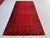A vintage Afghan Ersari Turkmen rug in the classic Bokhara design — tidy rows of small Tekke-style güls cover a bright,...