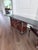 A fine dark mahogany drop-leaf buffet in the Chippendale tradition. Features two brass-handled drawers, two cabinet doors,...