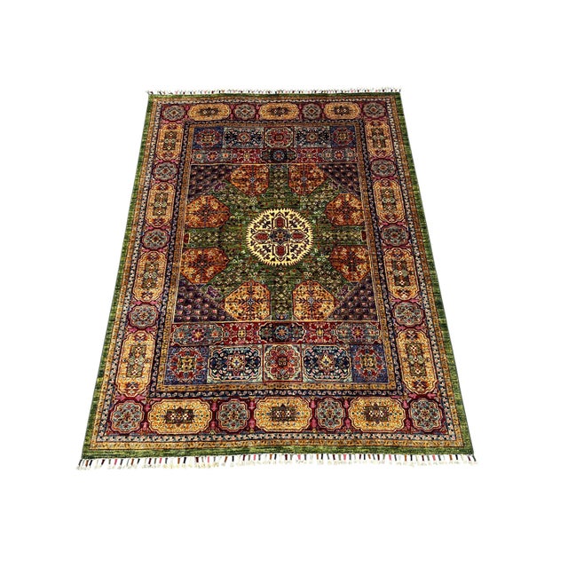 This Mamluk-design wool rug has an olive green center with an ivory rosette and surrounding motifs in rust, gold, navy,...