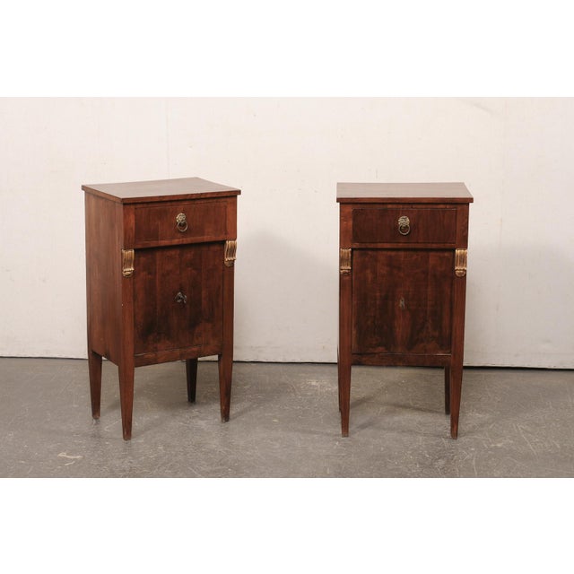A pair of Italian of wooden side chests from the 19th century. This pair of antique smaller cabinets from Italy each have...