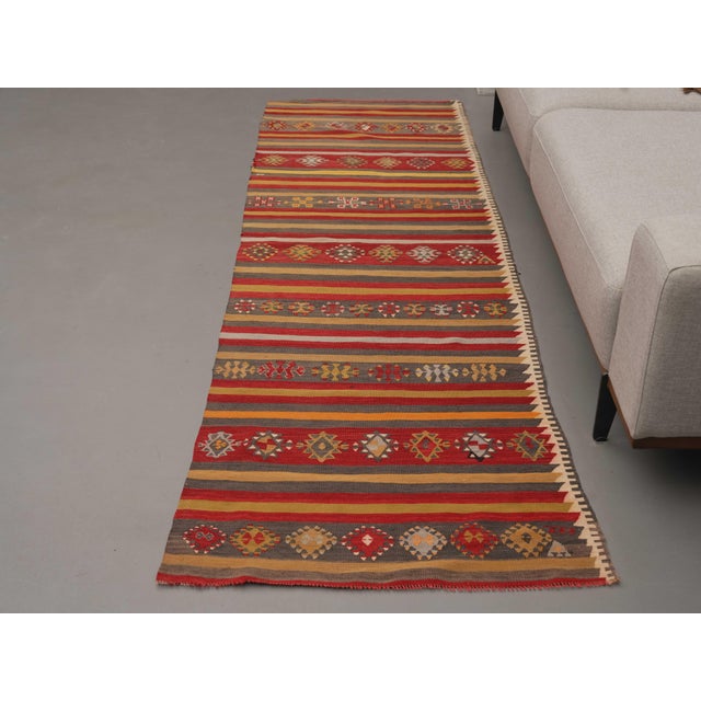 Vintage Hand-Knotted runner rug is a semi-antique vintage area rug. The '70s Eastern region of Anatolia's unique rug is...