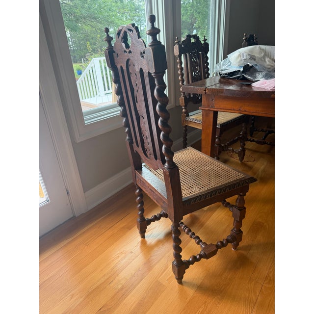 An exceptional set of six antique English Jacobean Revival dining chairs crafted from solid oak with beautifully hand-...