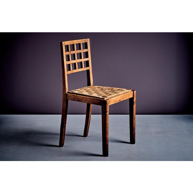 Side chair with geometric back and plain, sturdy construction recall the functional aesthetic linked to René Gabriel....