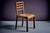 Side chair with geometric back and plain, sturdy construction recall the functional aesthetic linked to René Gabriel....