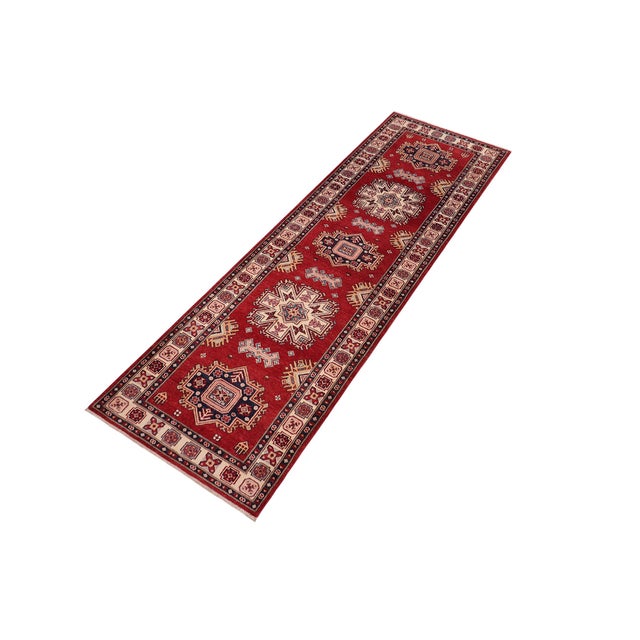 Enhance your home with this exquisite hand-knotted Super Kazak rug, crafted from fine hand-spun wool and dyed with all-...