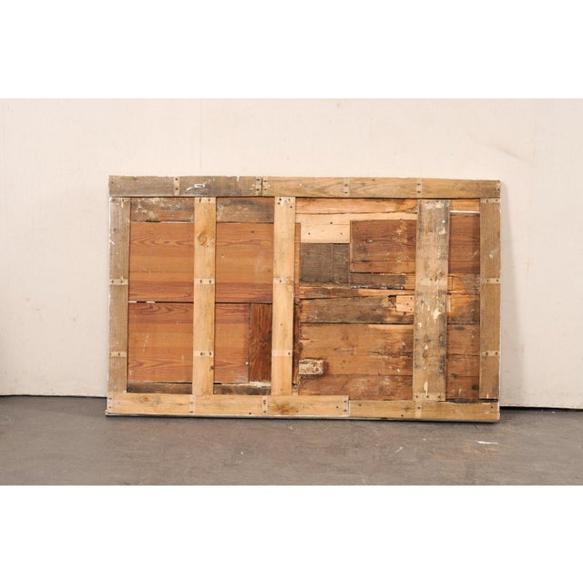 A French rectangular carved decorative wall panel from the 19th century. This antique wall ornament from France is...