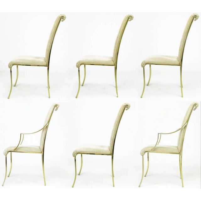 Set of six Design Institute of America brass and chenille upholstered dining chairs with Art Deco details. Four side...