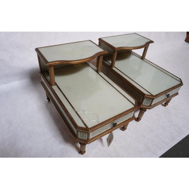 Two-tier nightstands / side tables with fleck opalescent material under the surface and a reverse-painted key design. The...