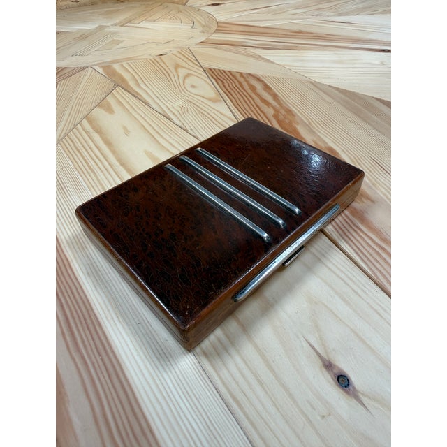 A refined vintage Italian decorative box crafted from richly figured burl wood with polished chrome accents. The...