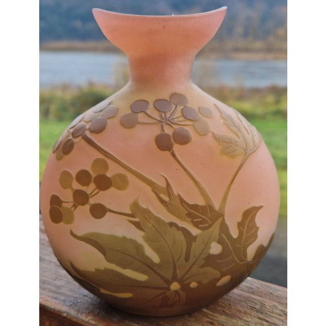 Circa 1900, French art glass vase of flattened ovoid form having a pink frosted glass body with two shades of green...