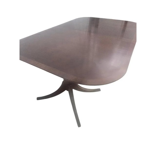 The Duncan Phyfe Mahogany Double Pedestal Dining Table has a refinished top and is a beautifully crafted piece of...