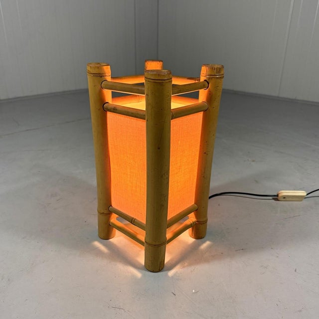 Rattan table lamp. Rattan frame with fabric screens. 1 small (E14) screw fitting. 1970’s. In good condition with minimal...