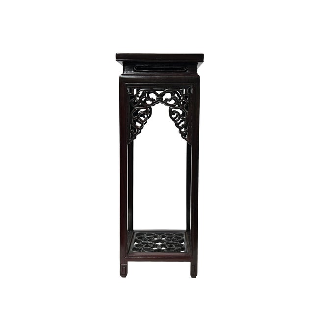 This elegant, oriental-inspired display stand is crafted from a deep, dark brown wood that features a rich, polished...