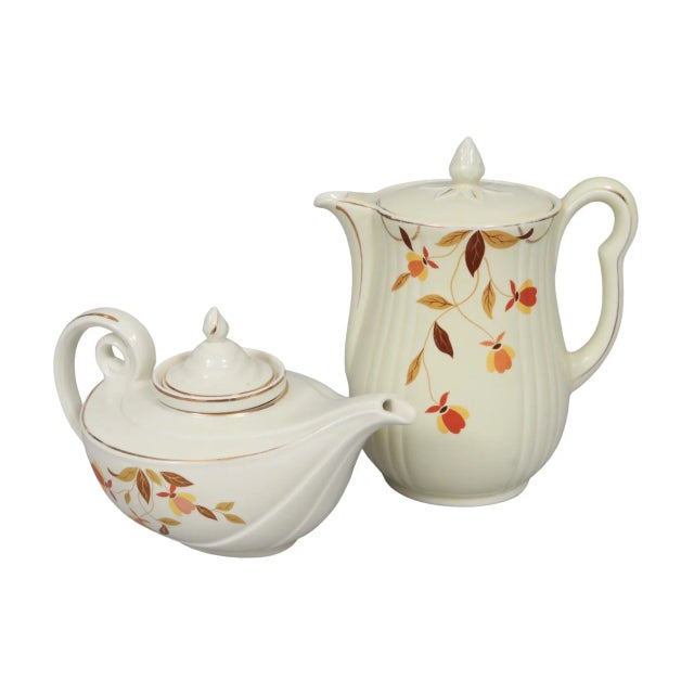 A ceramic tea and coffee pot set in the Autumn Leaf pattern by Hall's. This pattern was produced exclusively for Jewel Tea...