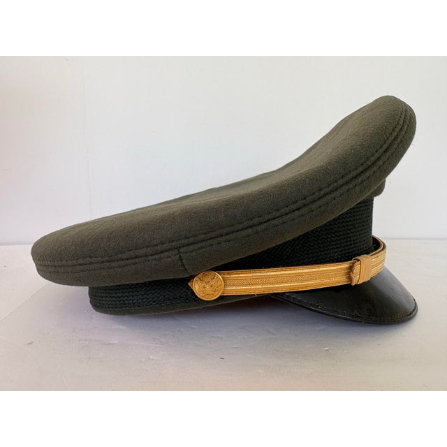 This is an authentic U.S. Army Officer’s visor cap manufactured by Bancroft Military Caps, Framingham, Massachusetts, one...