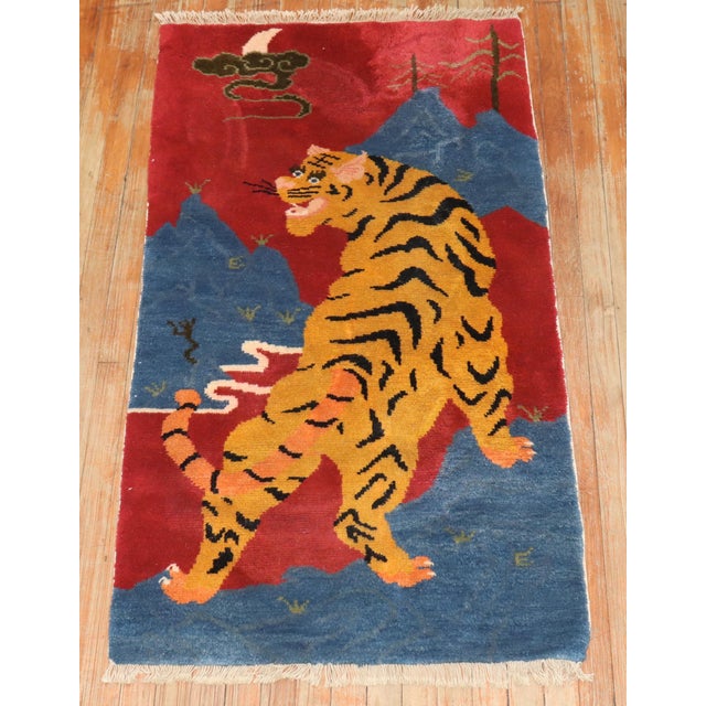 Rare Pair of Tiger Pictorial Tibetan Rugs from the 3rd quarter of the 20th century. One has a sun and the other has a moon...