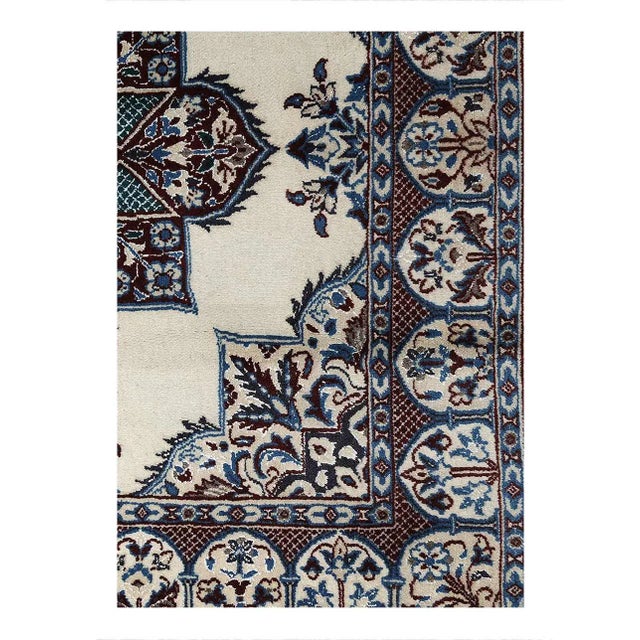 Persian Nain rugs are renowned for their detail and fine use of outlining along the central motifs. Breaking from the...