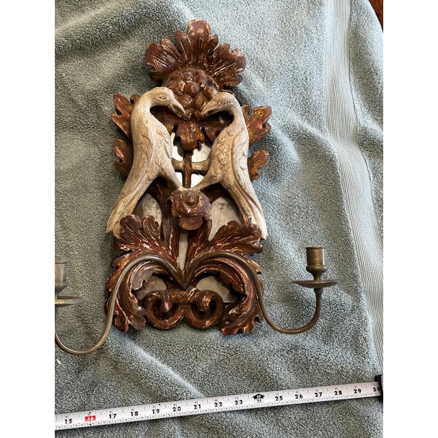 Description: A rare and finely carved pair of 18th century Portuguese Baroque wall sconces, hand-carved in solid wood with...