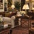 An extraordinary vintage Maitland-Smith side table featuring a leather-wrapped top with a studded border and inset glass...