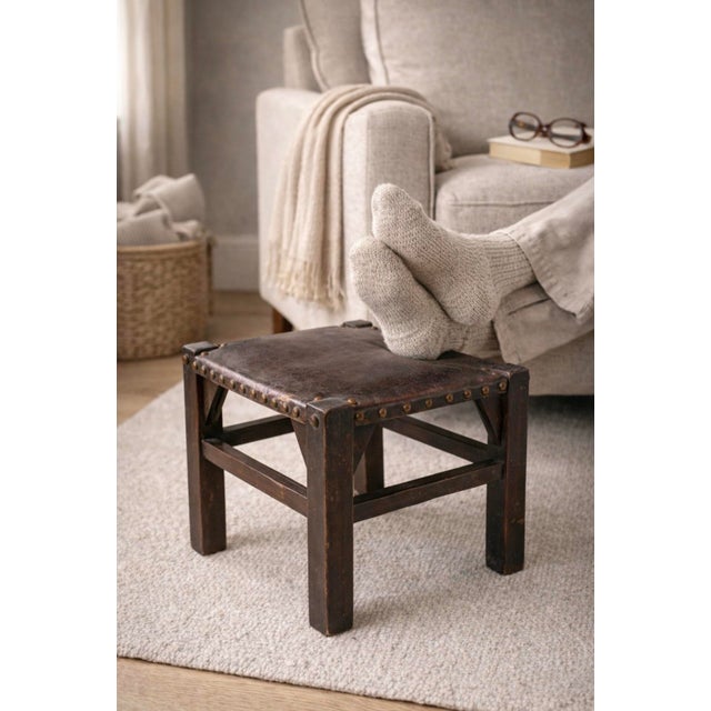 Timeworn Leather Footstool with Hand-Tacked Brass Studs