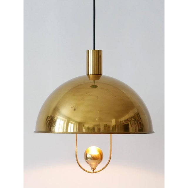 Rare and elegant mid-century modern solid-brass pendant lamp or hanging light. Designed and manufactured by florian...