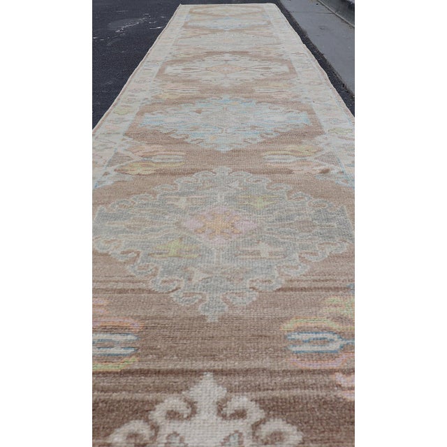 Long Turkish Oushak Runner With Pale Blue, Soft Yellow, and Light Brown Motifs For Sale - Image 10 of 13