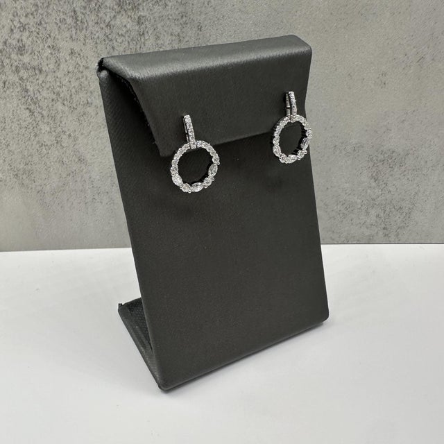 These stunning diamond circle drop earrings in 14kt white gold feature 1.3 carats total weight of natural GH SI round and...