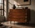 Danish chest of drawers produced by fm møbelfabrik in denmark during the 1960s. the cabinet showcases the dramatic natural...