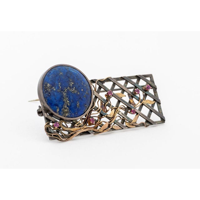 Sterling Silver and 14K Yellow Gold Lapis Ruby Brooch, featuring one bezel set round lapis cabochon weighing approx. 19.60...