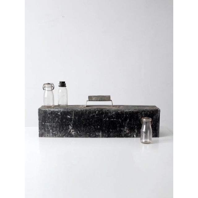 This rare early 20th century dairy milk sample testing kit retains its original transport case, numbered wooden carrier,...
