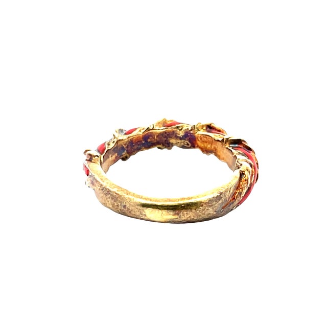 Striking vintage ring crafted in solid 14K yellow gold. Weighing 3.86 grams. Sized at 4. Featuring a bold orange enamel...