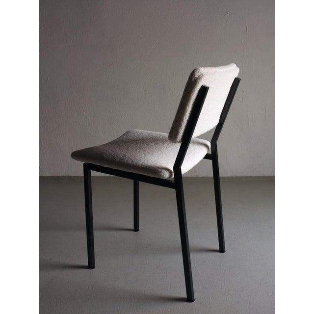 Vintage black metal chair with new off-white boucle upholstery designed by Gerrit Veenendaal for Kembo Rhenen. This piece...