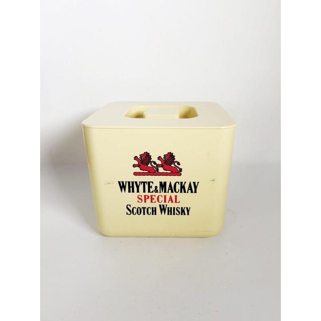Vintage French plastic ice bucket from the 1970s featuring Whyte & Mackay Special Scotch Whisky branding. Its square form...