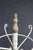 Cottage style white iron clothes tree with wood accents.
