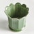 In a classic silhouette with petal edges, this footed pot is natureinspired. Finished in a soft verdant reactive glaze, it...
