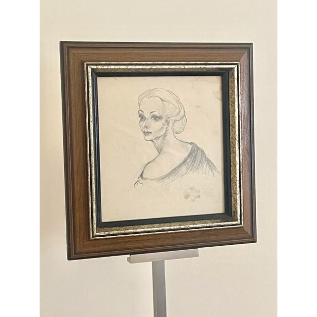 The original pencil drawing on paper depicts the portrait of a French classy clad lady peering over her shoulder. The...