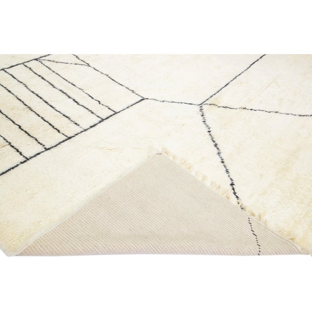 Beautiful modern Moroccan style hand-knotted wool rug with a white field and fringes in a gorgeous geometric abstract high...