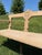 Mid 20th Century Swiss bench featuring a beautifully carved crest detailing and a softly weathered oak finish. A chariming...